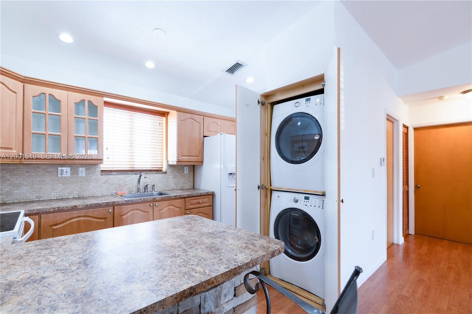 10017 West Okeechobee Road, Unit 202 Hialeah Gardens, FL 33016 - Photo 6 of 30 a view of a kitchen with sink washer and dryer
