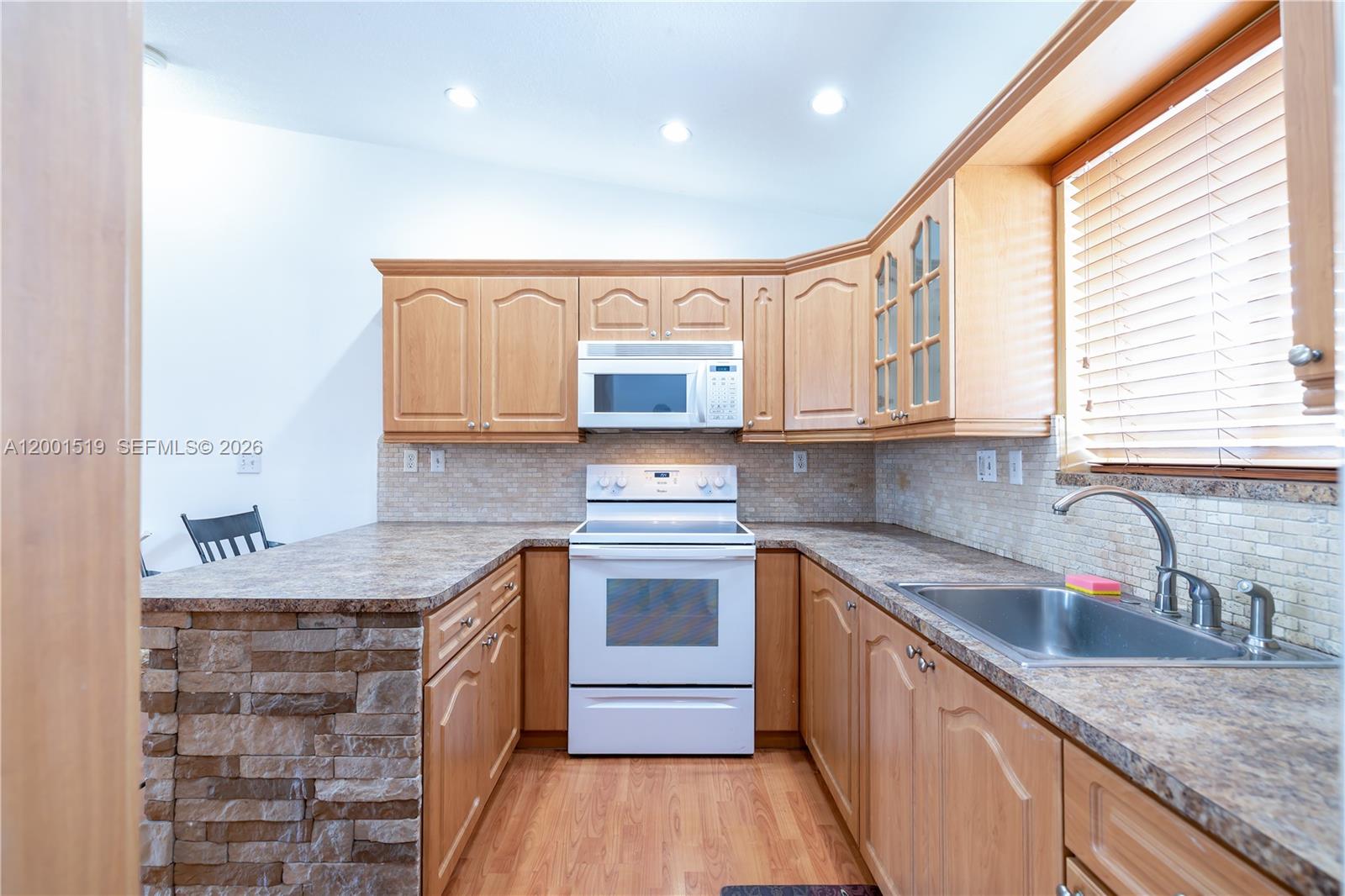 10017 West Okeechobee Road, Unit 202 Hialeah Gardens, FL 33016 - Photo 8 of 30 a kitchen with stainless steel appliances granite countertop a sink stove and cabinets