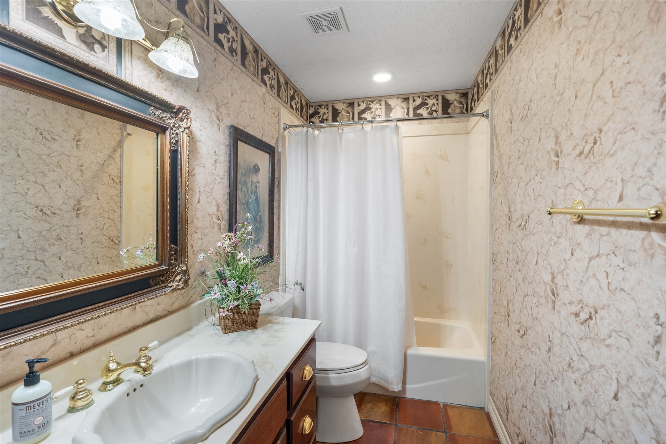 186 Lake Road Huntsville, TX 77320 - Photo 16 of 48 a bathroom with a granite countertop sink a toilet and shower curtain