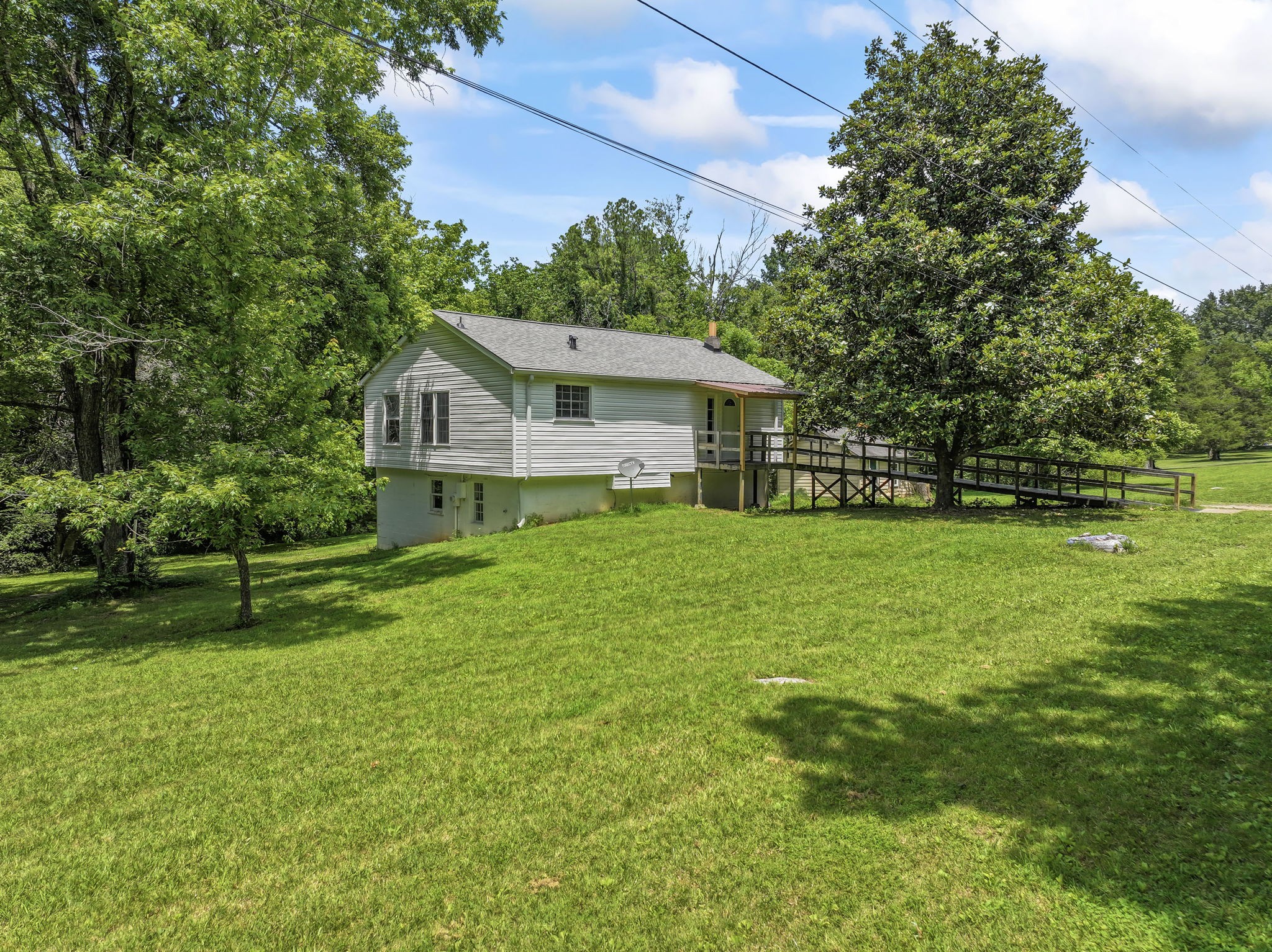 7723 Almaville Road Murfreesboro, TN 37128 - Photo 2 of 5 a view of a house with a yard deck and a large tree