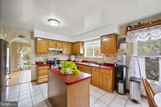 a kitchen with a sink appliances and cabinets