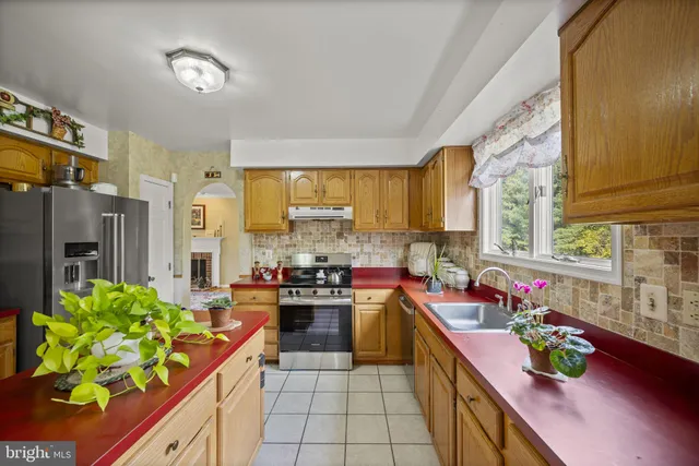a kitchen with stainless steel appliances a stove a sink and a refrigerator