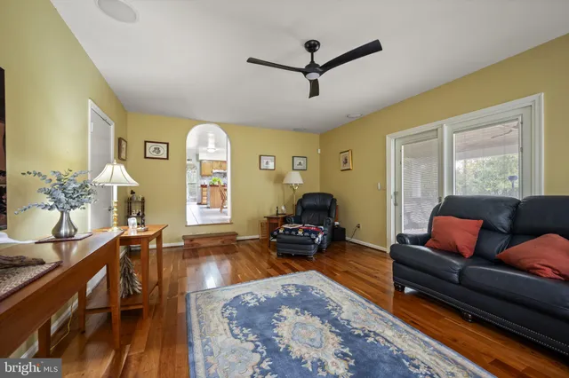 a living room with furniture fireplace and a large window