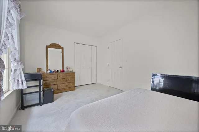 a bedroom with a bed and a lamp