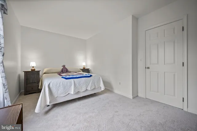 a bedroom with a bed and dresser