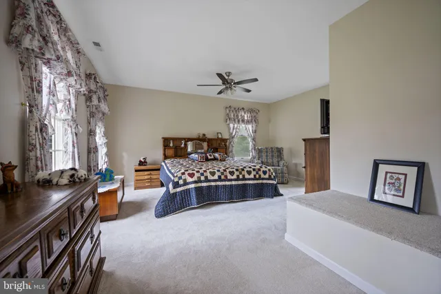 a bedroom with a bed couch and window