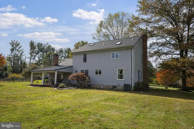 a view of a house with backyard porch and sitting area