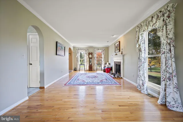 a view of entryway livingroom and hall with wooden floor