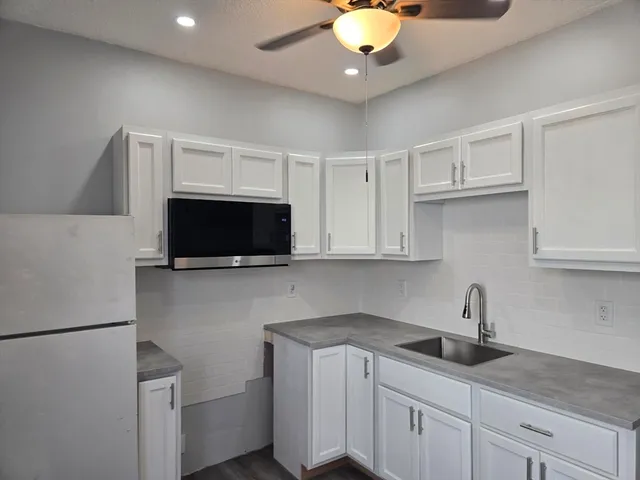 a kitchen with a sink and a stove top oven