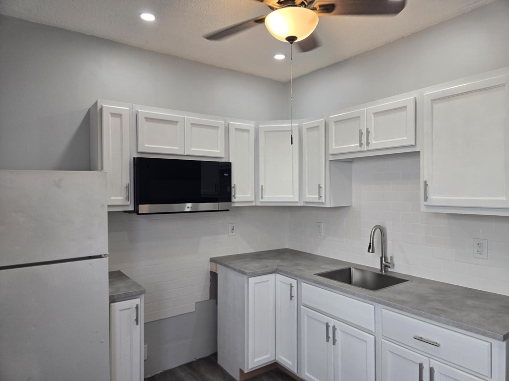 90 Quequechan Street, Unit 2 Fall River, MA 02723 - Photo 11 of 20 a kitchen with a sink and a stove top oven