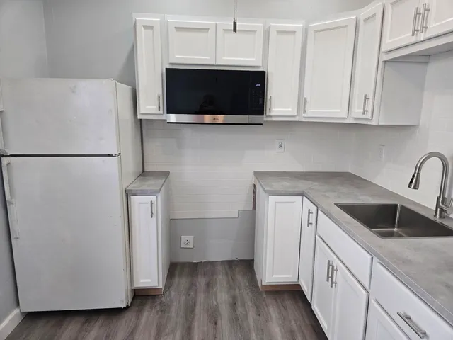 a kitchen with a microwave and a sink