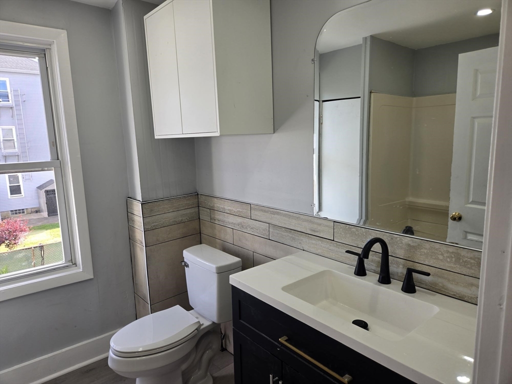 90 Quequechan Street, Unit 2 Fall River, MA 02723 - Photo 13 of 20 a bathroom with a sink toilet and mirror