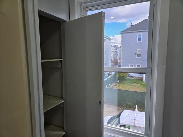 a bathroom with a glass shower door and a mirror