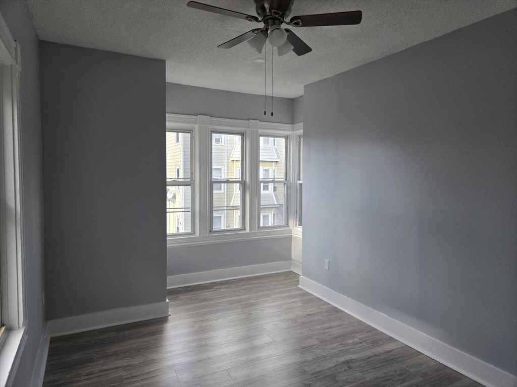 90 Quequechan Street, Unit 2 Fall River, MA 02723 - Photo 17 of 20 wooden floor in an empty room with a window