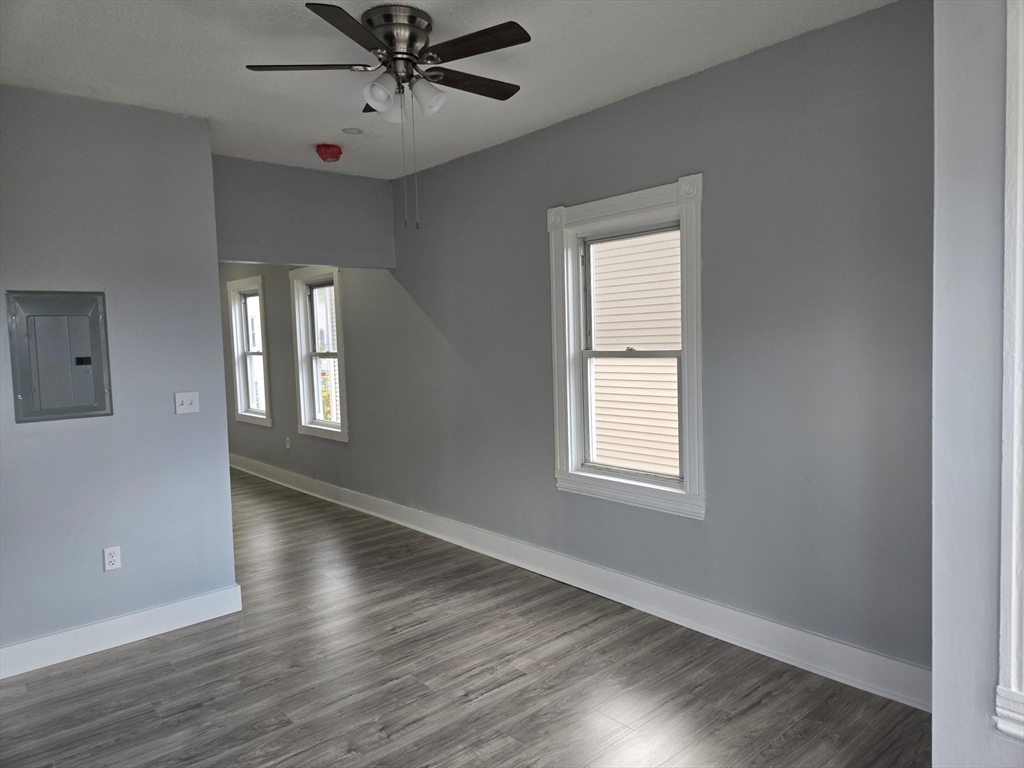 90 Quequechan Street, Unit 2 Fall River, MA 02723 - Photo 18 of 20 a view of an empty room with wooden floor and a window