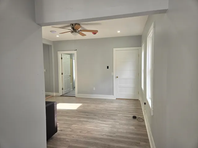 a view of a hallway with wooden floor