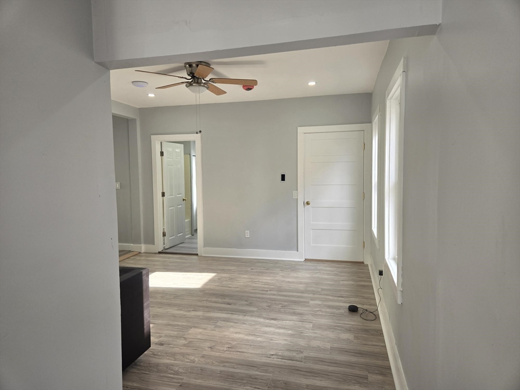 90 Quequechan Street, Unit 2 Fall River, MA 02723 - Photo 2 of 20 a view of a hallway with wooden floor