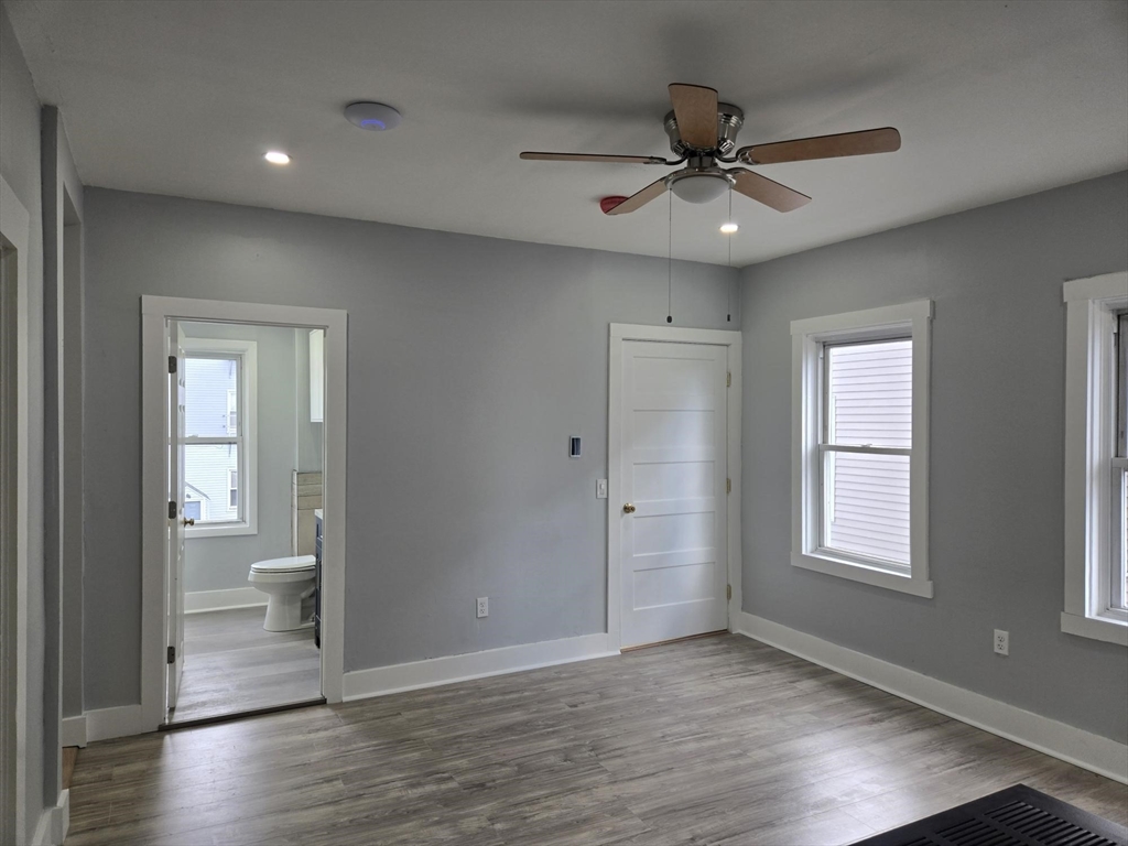 90 Quequechan Street, Unit 2 Fall River, MA 02723 - Photo 3 of 20 a view of an empty room and window and wooden floor