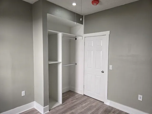 a view of walk in closet with empty racks