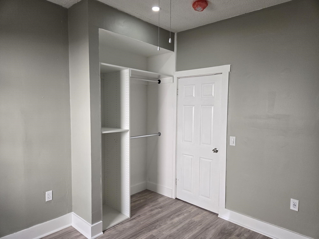 90 Quequechan Street, Unit 2 Fall River, MA 02723 - Photo 9 of 20 a view of walk in closet with empty racks