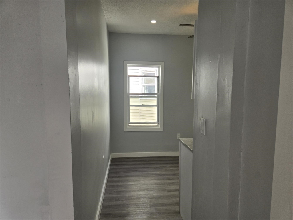 90 Quequechan Street, Unit 2 Fall River, MA 02723 - Photo 10 of 20 a view of a hallway with wooden floor