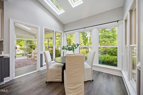 a spacious bedroom with a bed and wooden floor