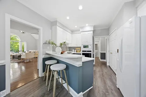 a dining room with furniture a potted plant a sink and a window
