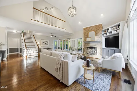 a living room with furniture a fireplace and a flat screen tv