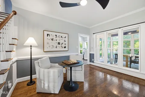 a living room with furniture and wooden floor