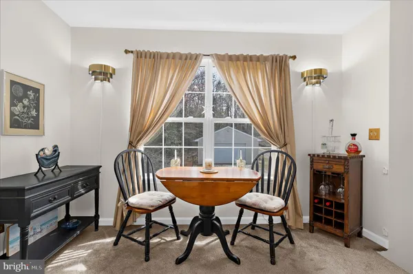 a view of a livingroom with furniture and a window