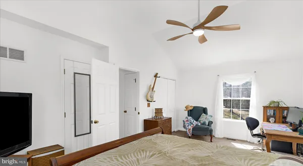 a bedroom with a bed and a large window