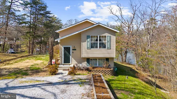 a front view of house with yard outdoor seating and barbeque oven