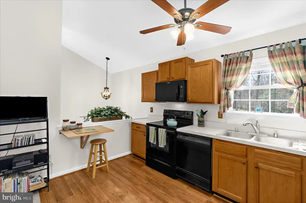 a kitchen with a stove a sink and a microwave