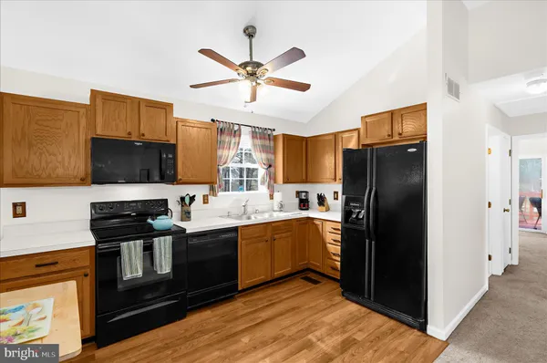 a kitchen with stainless steel appliances granite countertop a refrigerator stove microwave and sink
