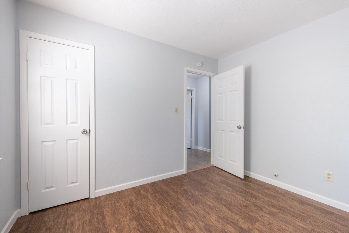 606 West Street Georgetown, TX 78626 - Photo 21 of 36 Unfurnished bedroom with dark wood-style floors and baseboards
