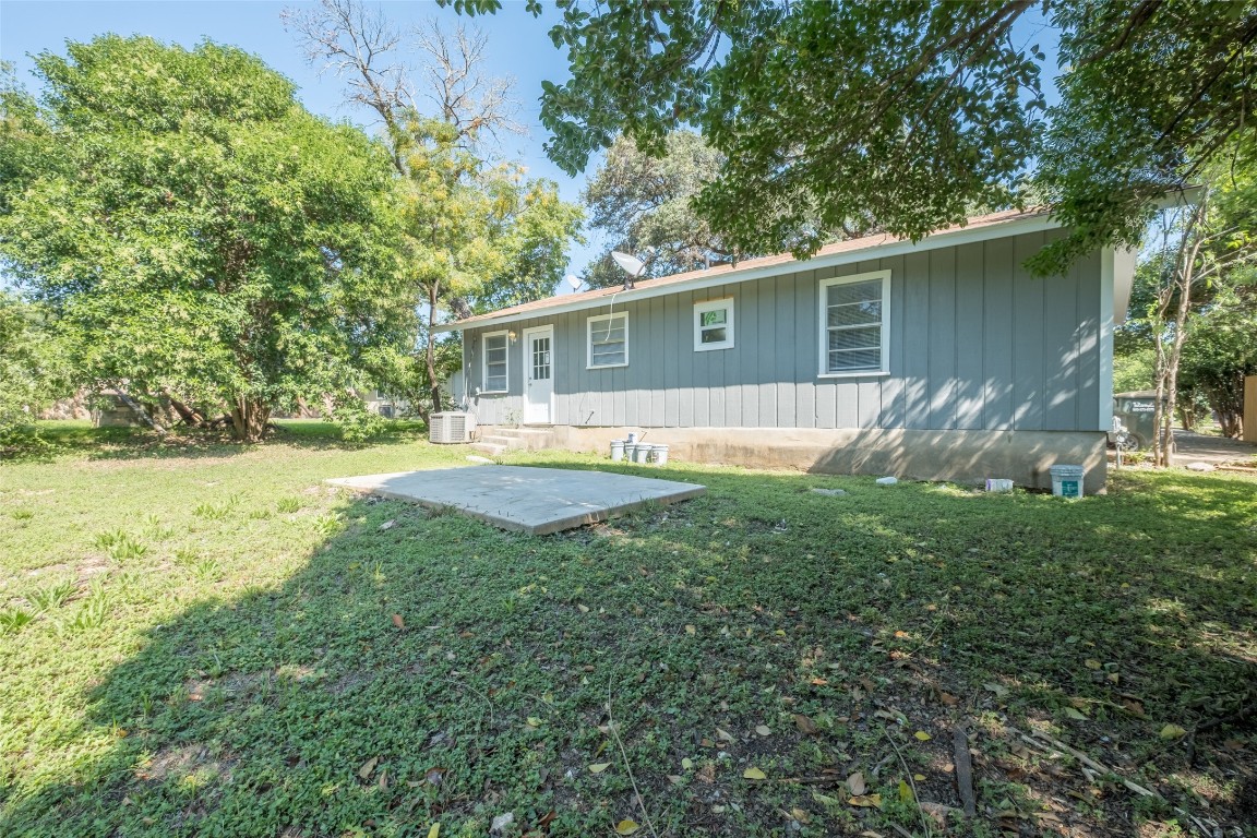 606 West Street Georgetown, TX 78626 - Photo 22 of 36 Rear view of property with a patio area, board and batten siding, and a lawn