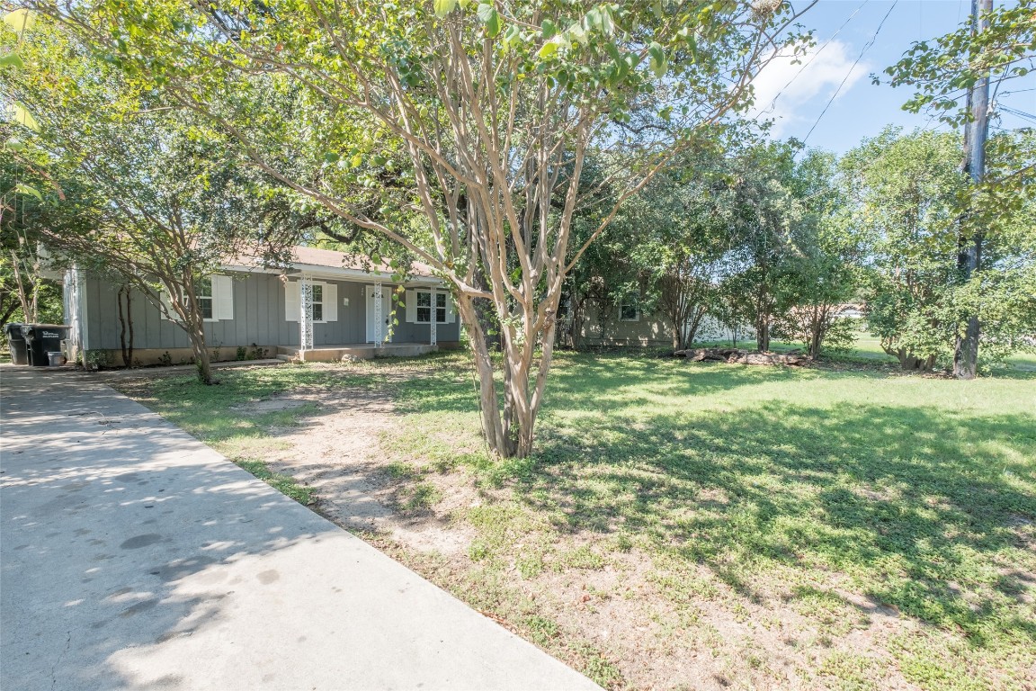 606 West Street Georgetown, TX 78626 - Photo 32 of 36 View of grassy yard featuring covered porch