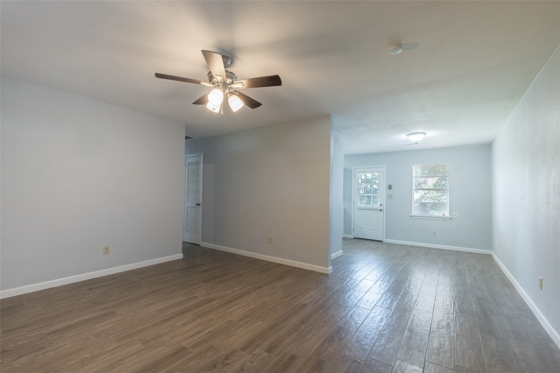 606 West Street Georgetown, TX 78626 - Photo 5 of 36 Empty room with dark wood-style flooring and a ceiling fan