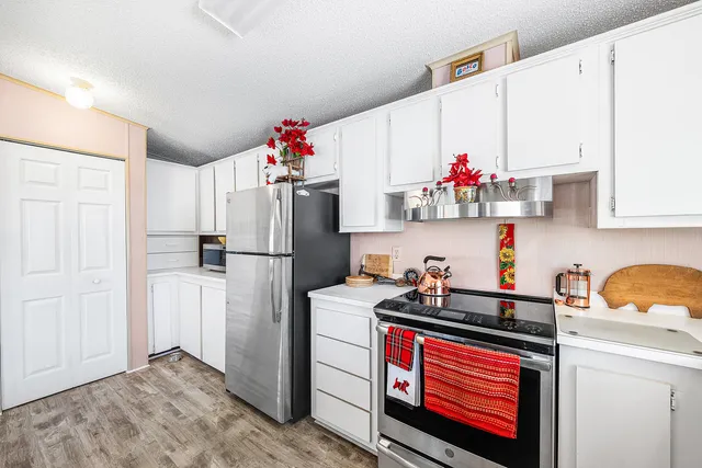 a kitchen with a refrigerator and cabinets