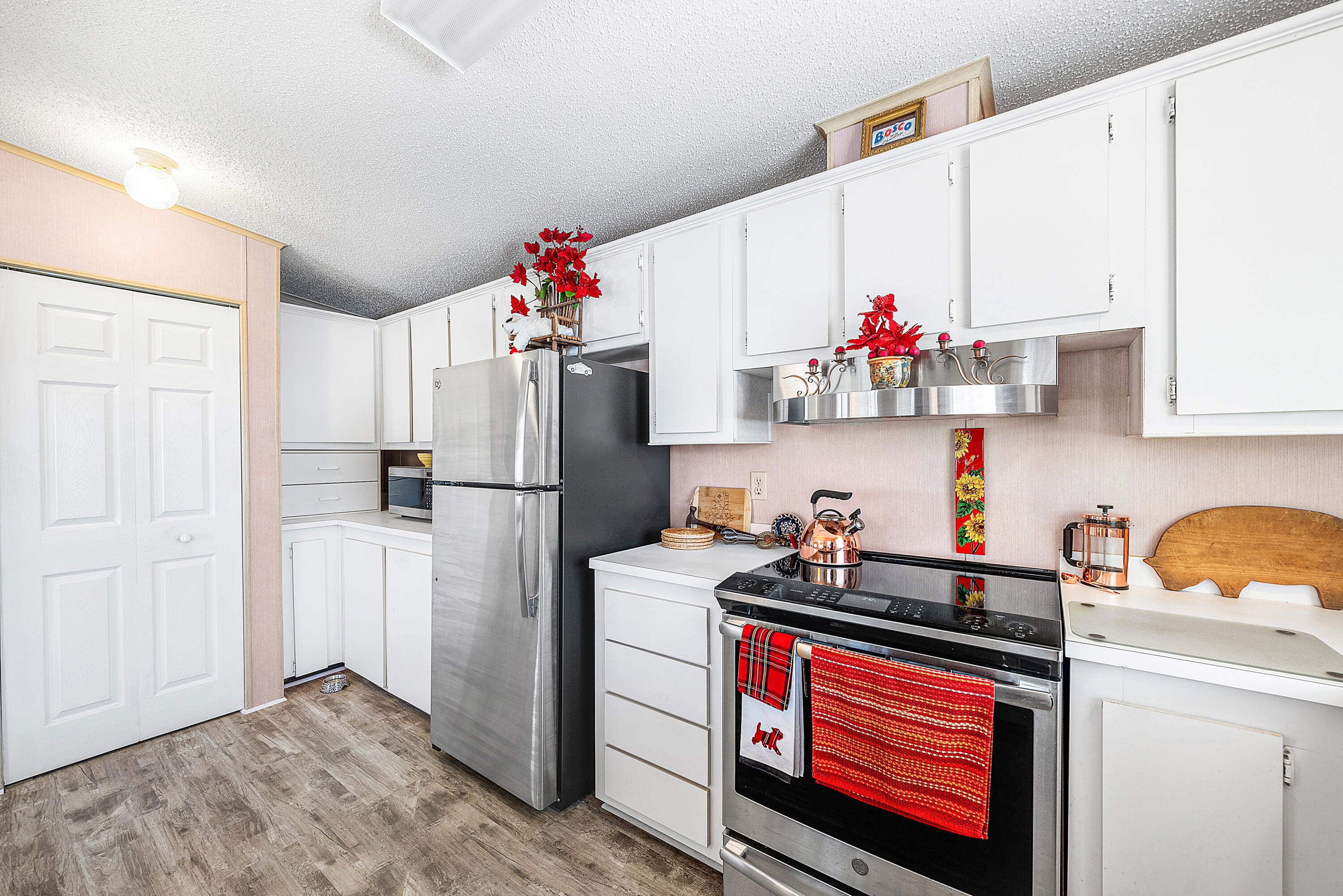 4 East Cedar Drive, Unit CD Briny Breezes, FL 33435 - Photo 12 of 28 a kitchen with a refrigerator and cabinets