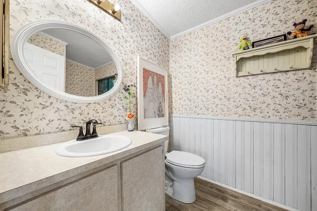 a bathroom with a toilet sink and mirror