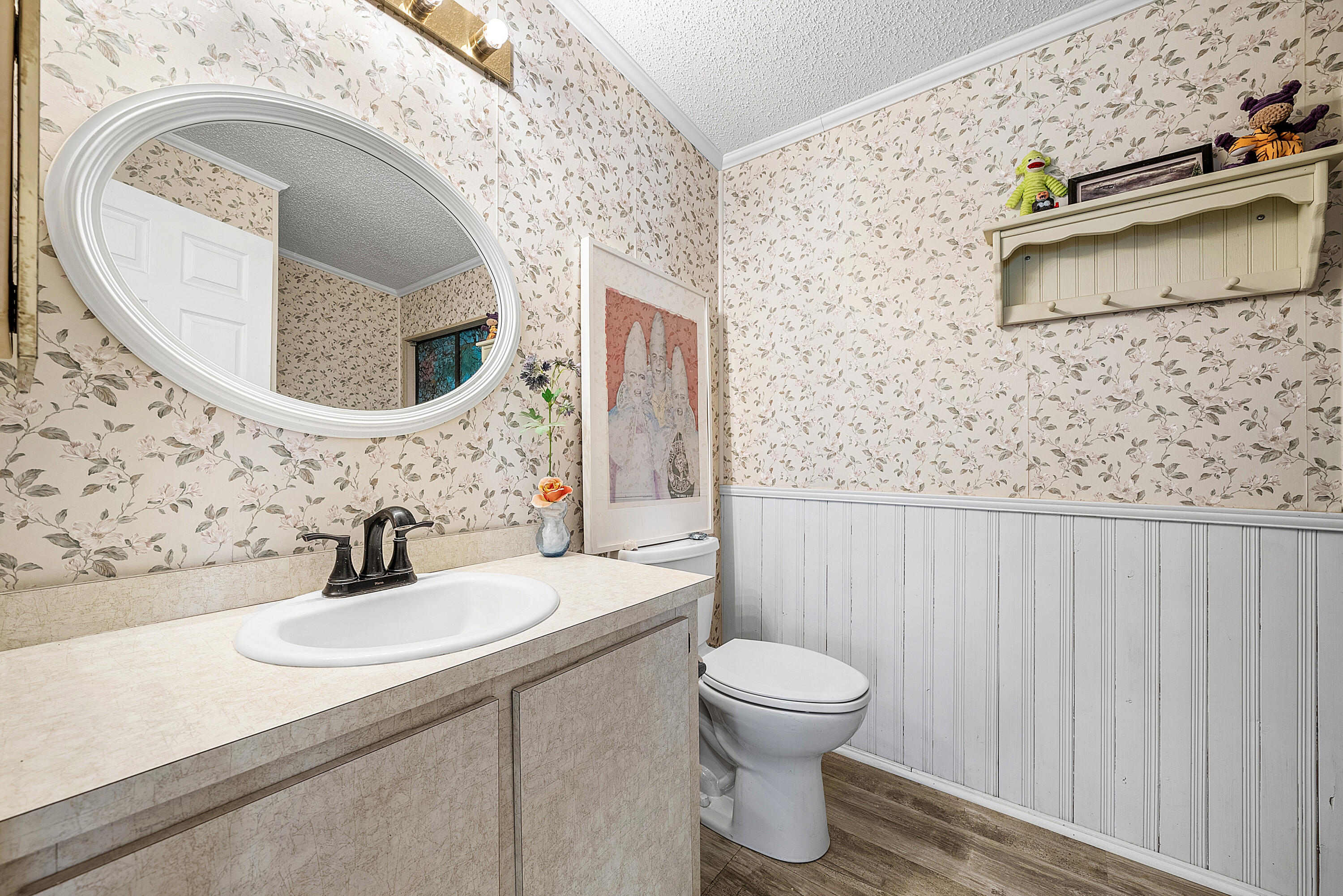 4 East Cedar Drive, Unit CD Briny Breezes, FL 33435 - Photo 14 of 28 a bathroom with a toilet sink and mirror