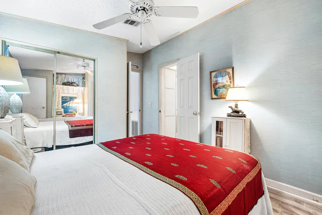 a bedroom with a large bed and a chandelier