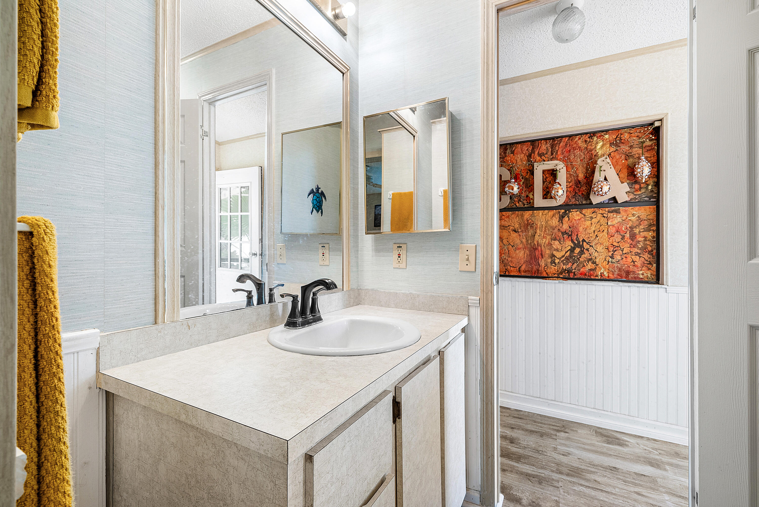 4 East Cedar Drive, Unit CD Briny Breezes, FL 33435 - Photo 18 of 28 a bathroom with a sink a vanity and a large mirror