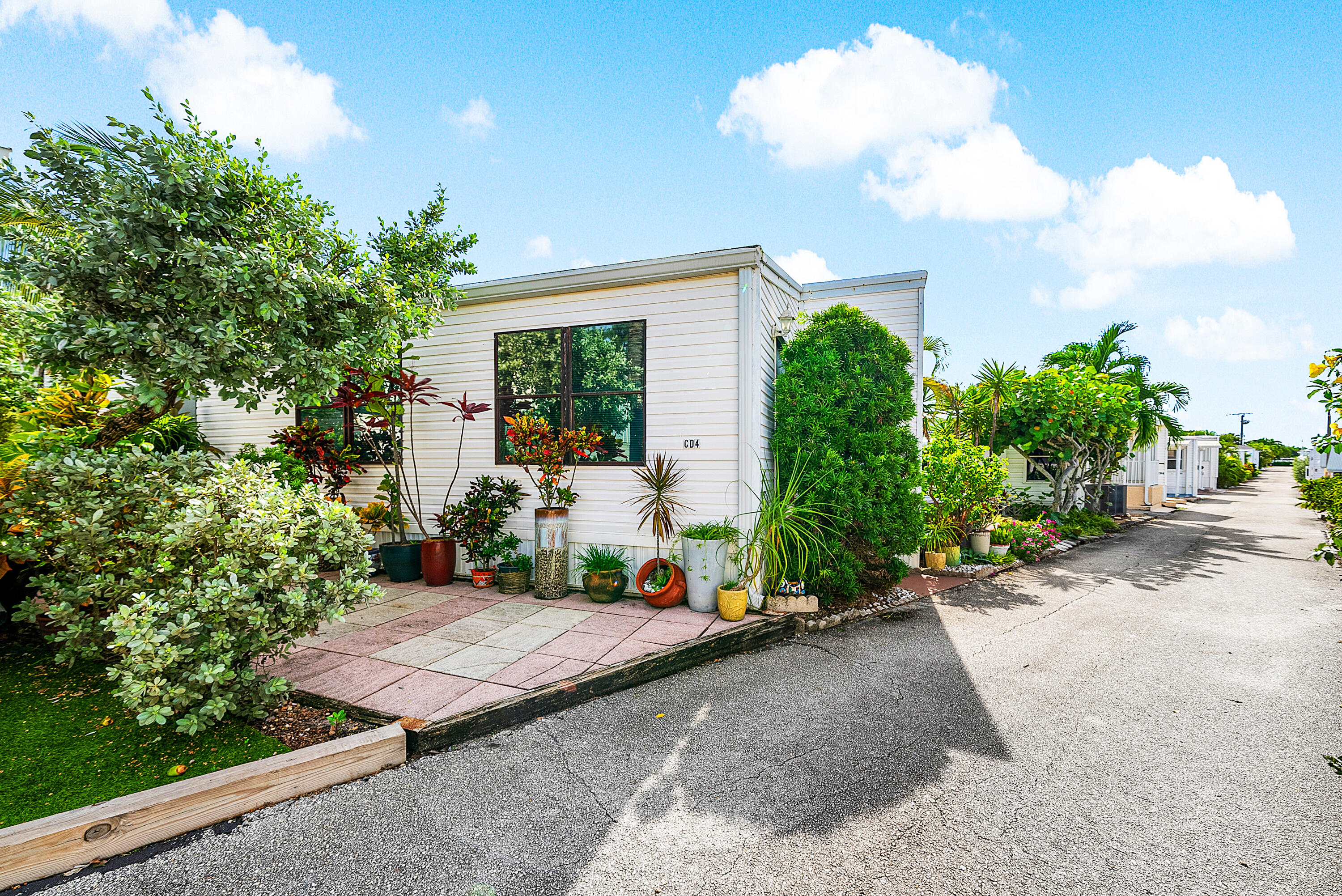 4 East Cedar Drive, Unit CD Briny Breezes, FL 33435 - Photo 25 of 28 a view of a backyard with plants and a garden