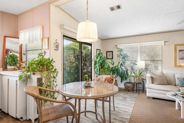 a view of a dining room with furniture window and outside view
