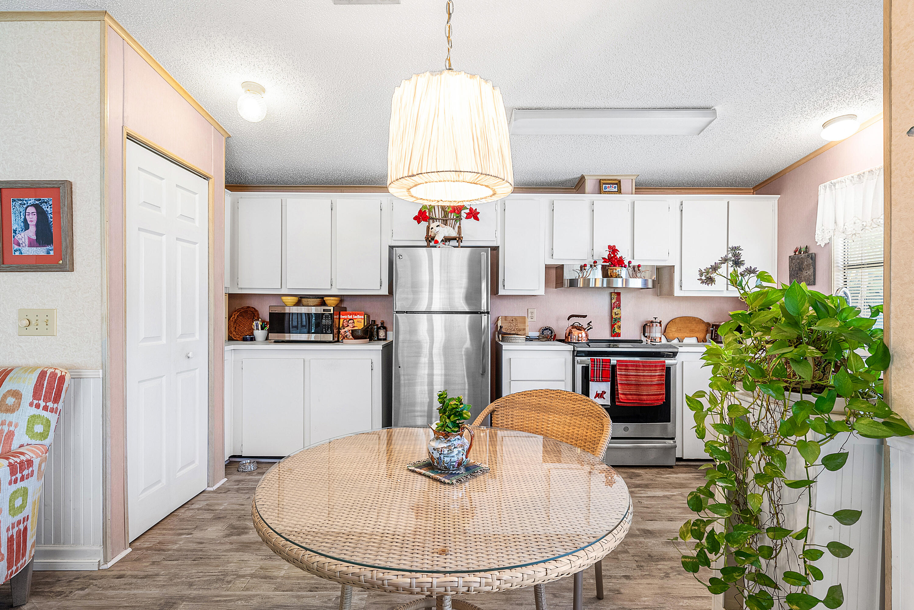 4 East Cedar Drive, Unit CD Briny Breezes, FL 33435 - Photo 9 of 28 a kitchen with stainless steel appliances granite countertop a refrigerator a microwave a stove and a dining table