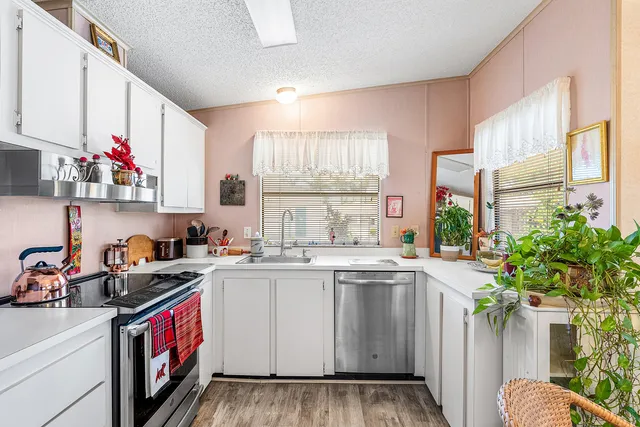 a kitchen with a sink stove and cabinets