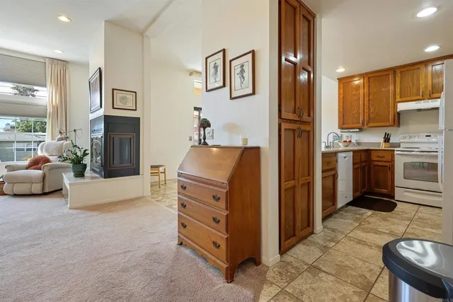 a kitchen with stainless steel appliances kitchen island granite countertop a refrigerator and cabinets