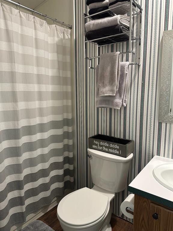 21516 Water Ridge Road Chandler, TX 75758 - Photo 15 of 40 a white toilet sitting next to a bathroom sink